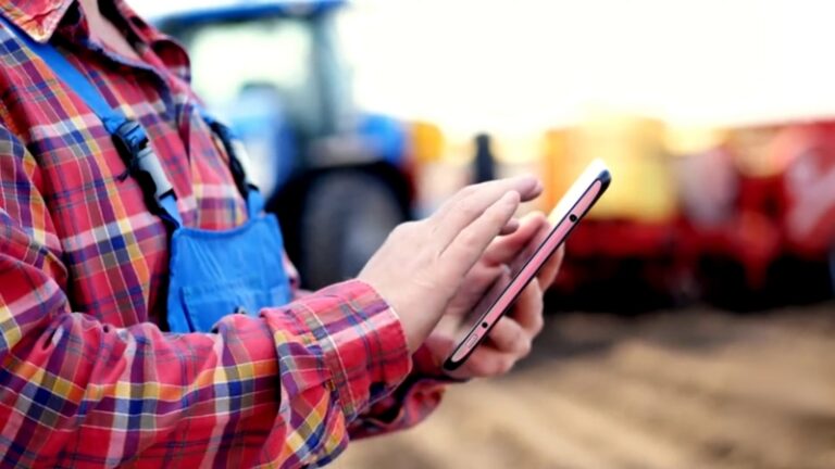 Farmer using GPS guidance systems in farming on a tablet for precise field work
