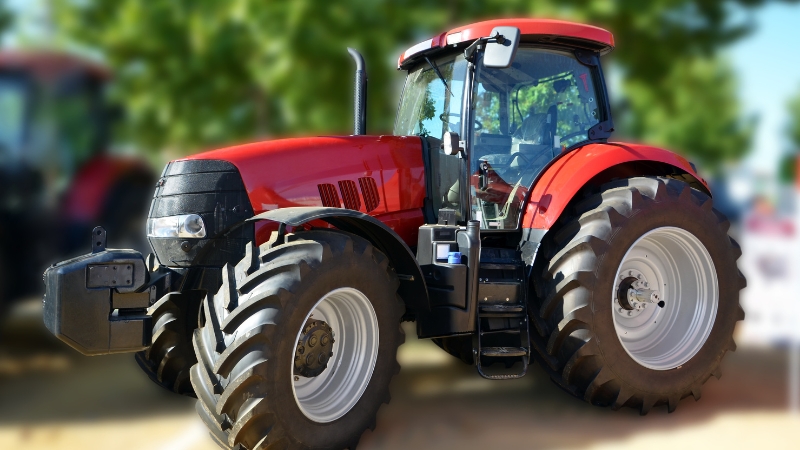 A red modern tractor parked outdoors